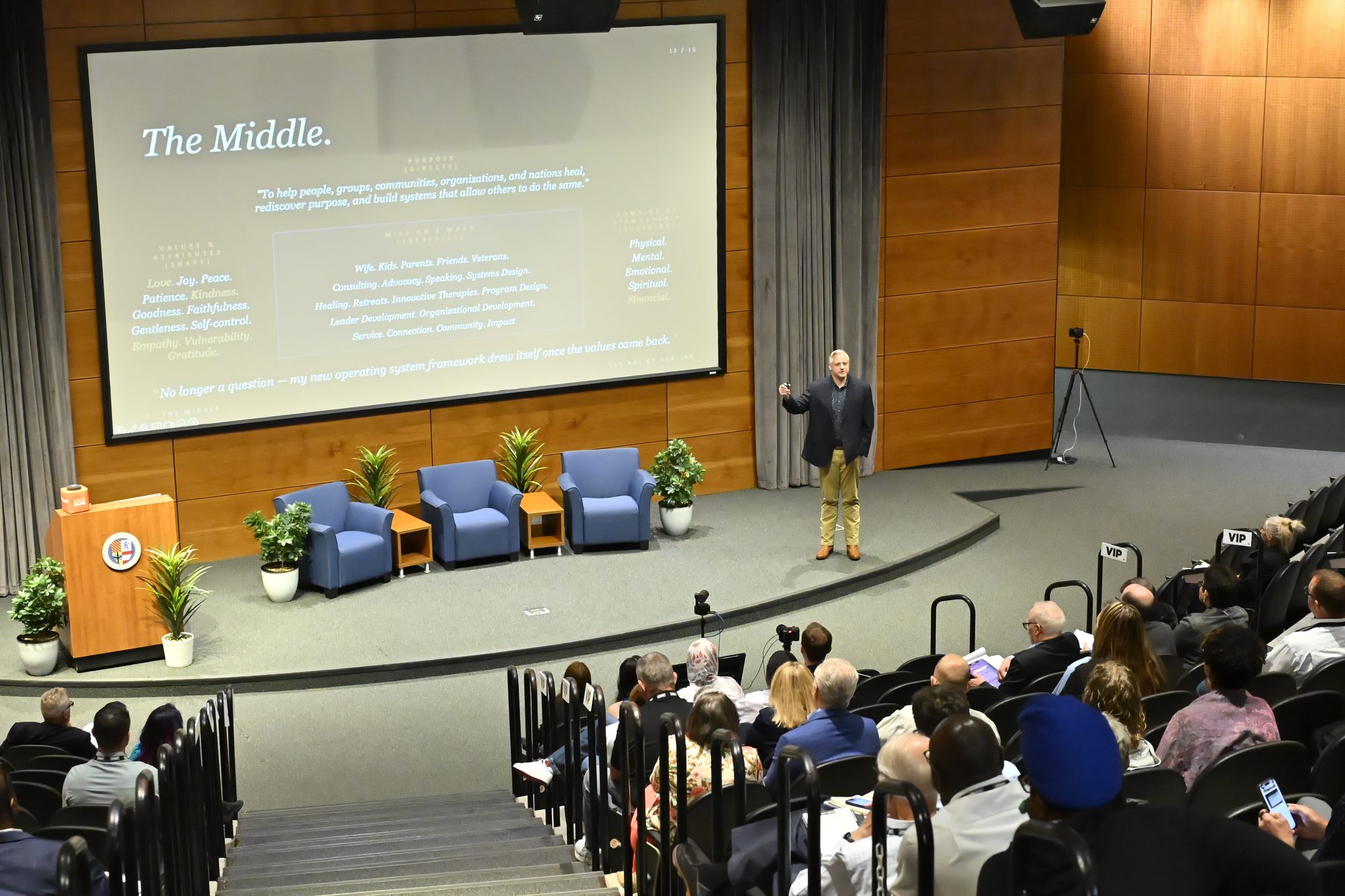 Adam Marr delivering a keynote to a full auditorium